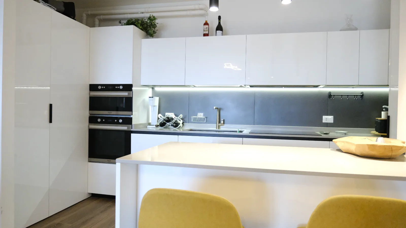 Attico SB, Verona — the finished kitchen with its island and pale units