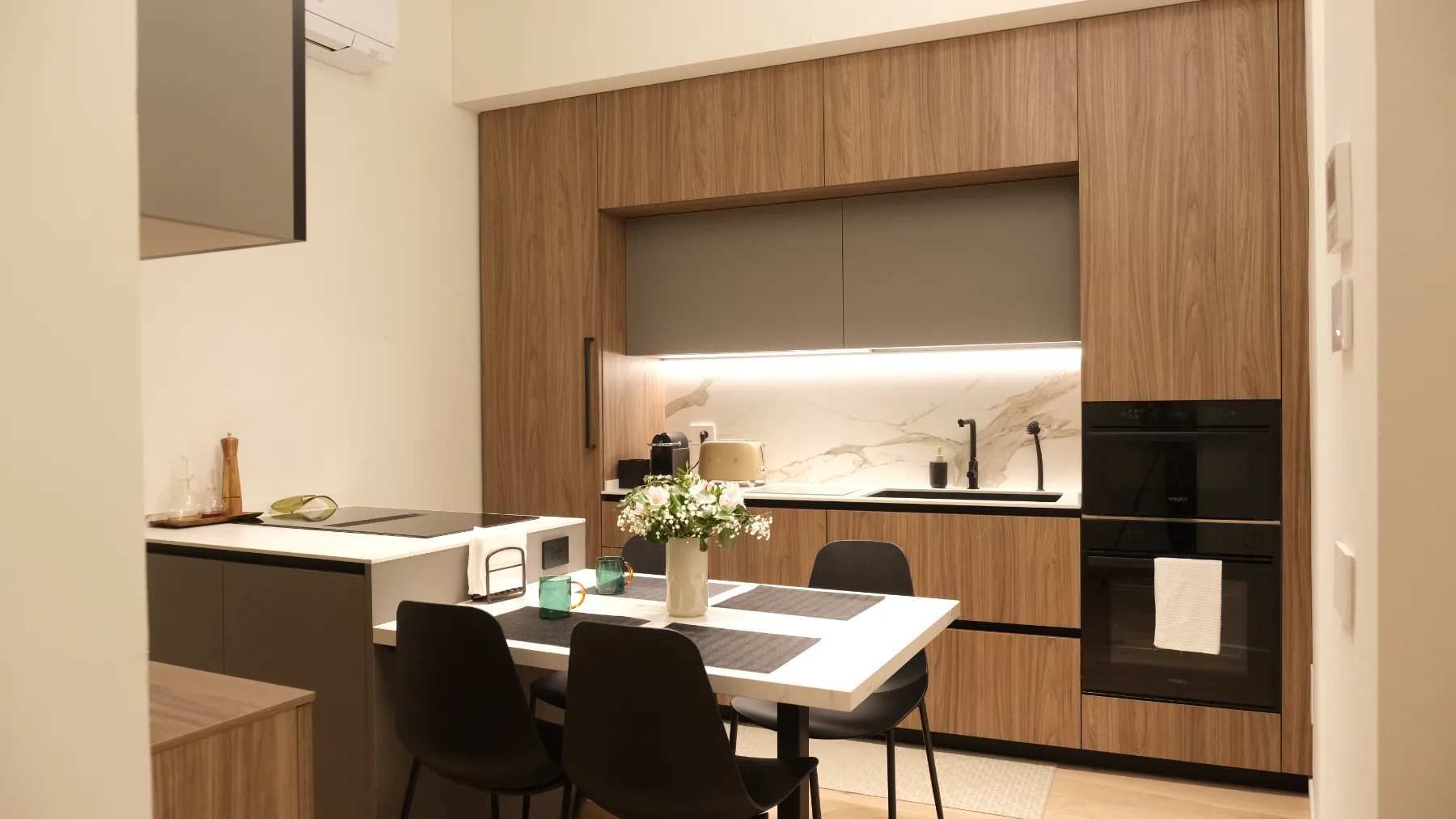 Casa Patio, Verona — the finished kitchen and dining area in walnut and stone