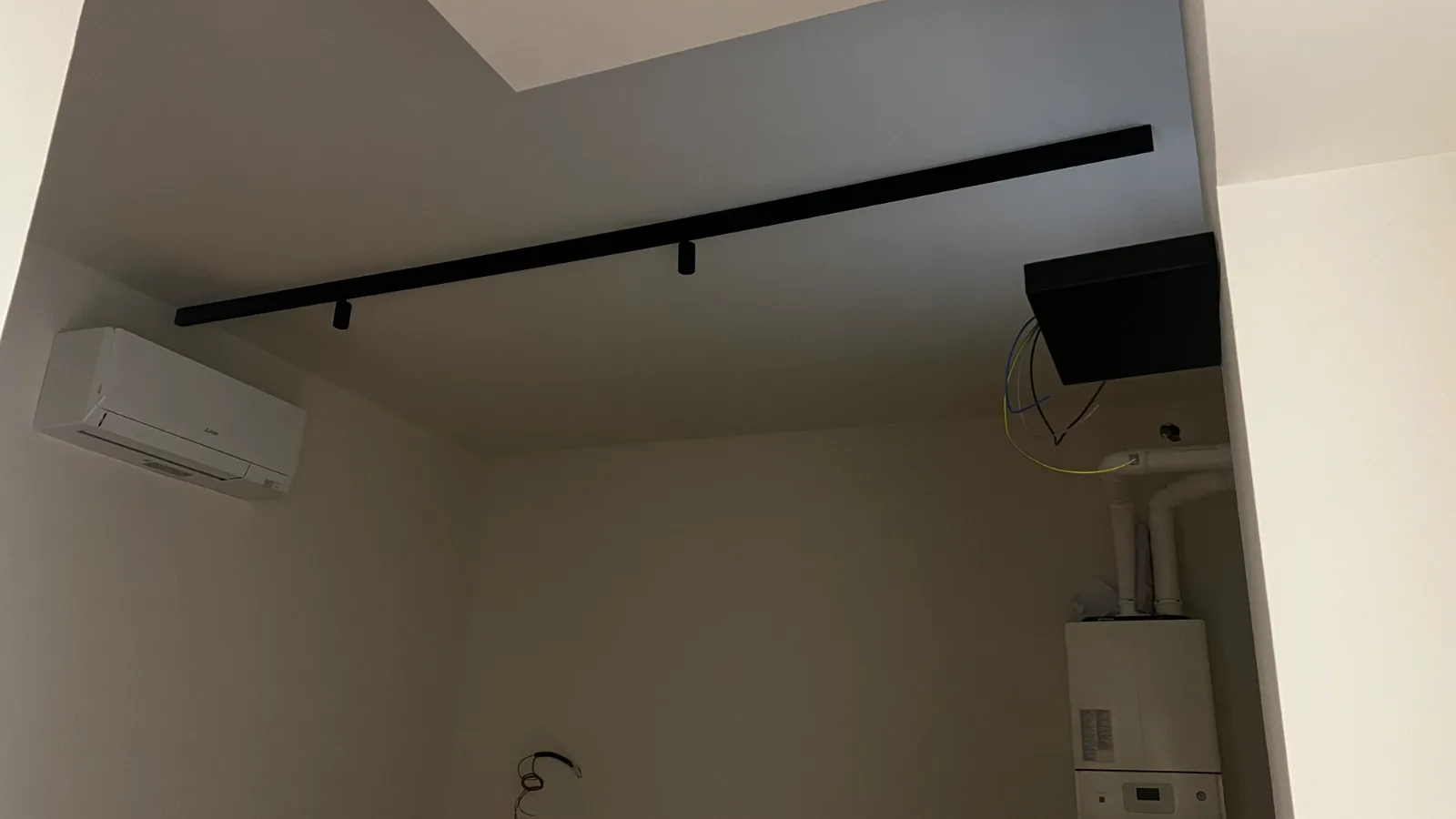Casa Patio before the works — the same room with services and wiring still exposed
